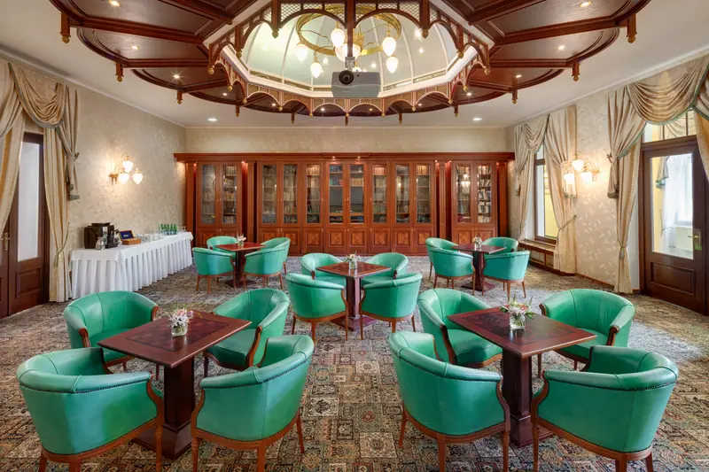 Bookcases and armchairs in Edward's Library at Hotel Nové Lázně