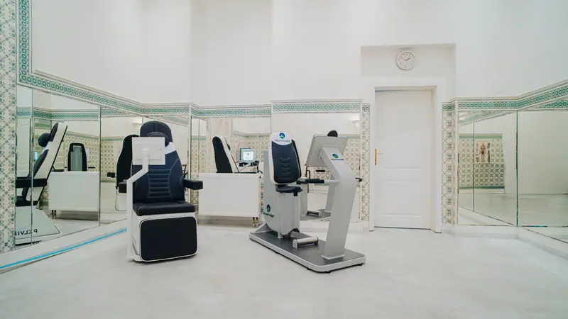 PelviPower therapeutic chair and diagnostic unit in a bright, mirrored treatment room at the Nové Lázně hotel