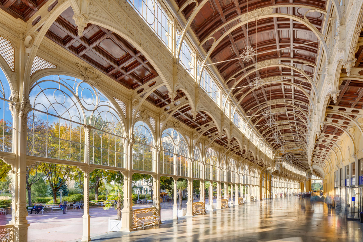The cast-iron Main Colonnade in Marienbad with its painted ceiling and promenading guests