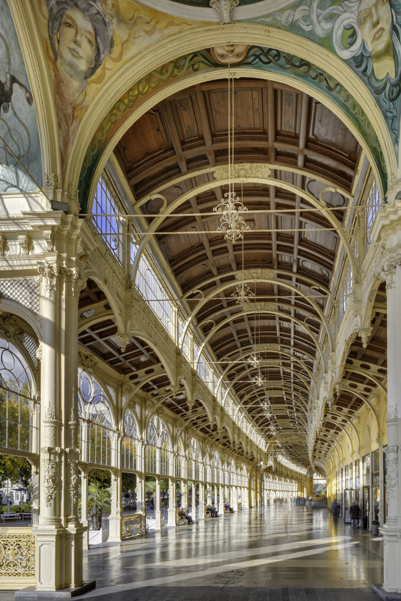 Looking up into the cast-iron vault of the colonnade, with chandelier and painted ceiling