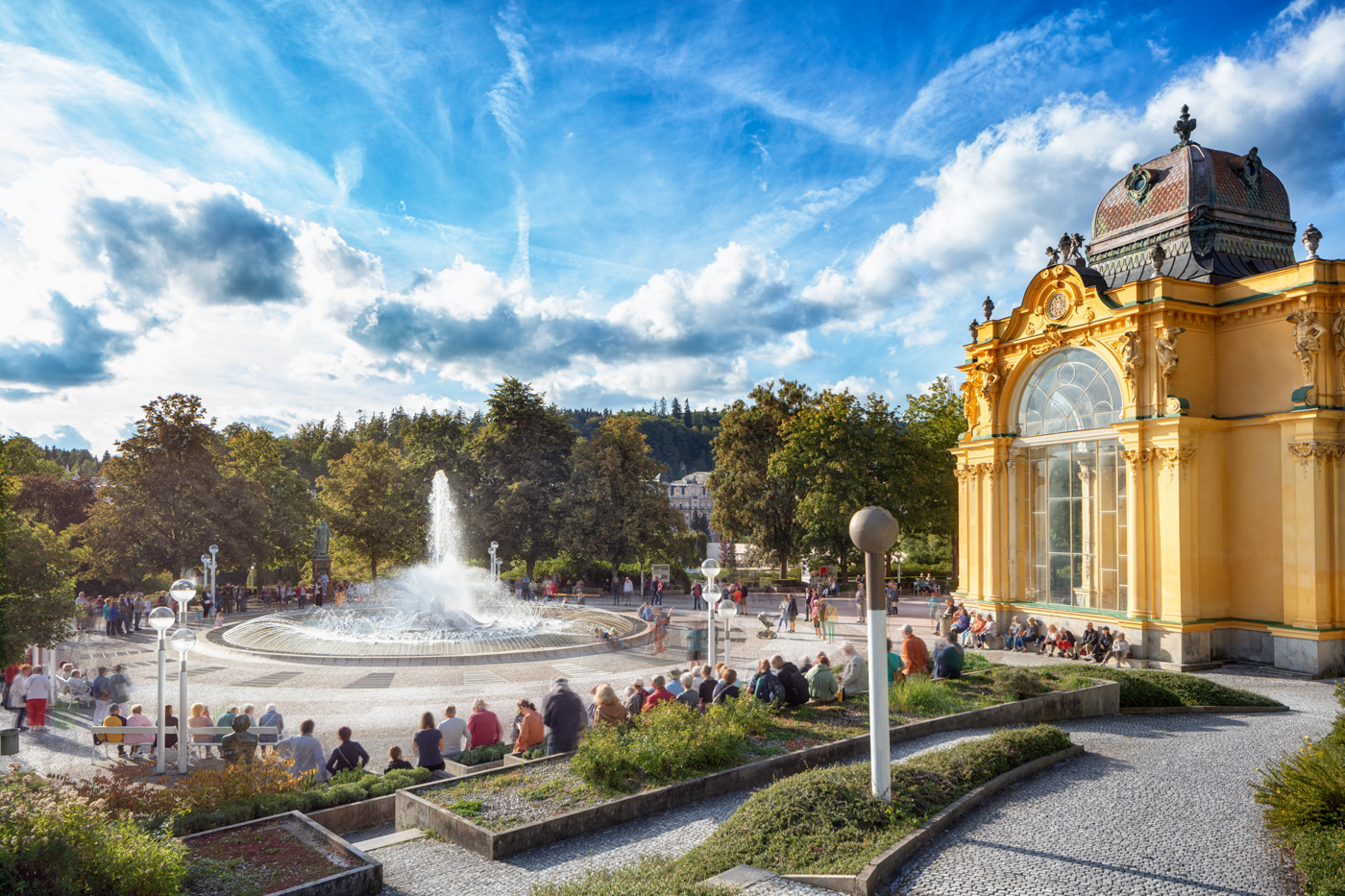 An audience seated around the Singing Fountain during a performance