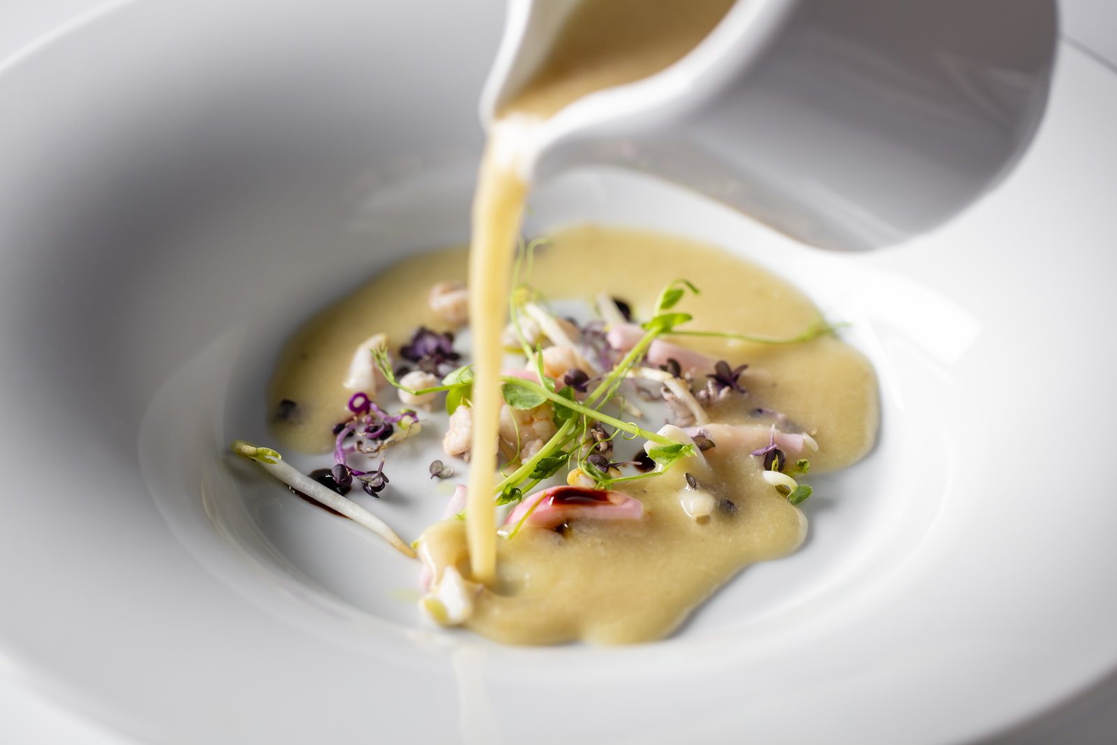 Cream soup poured at the table